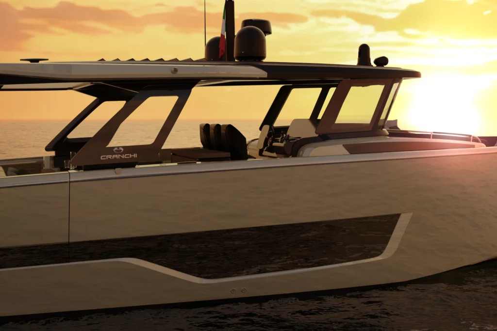 Cranchi A48 O/B visto lateralmente al tramonto, con hard top, plancia di comando e ampie vetrature.